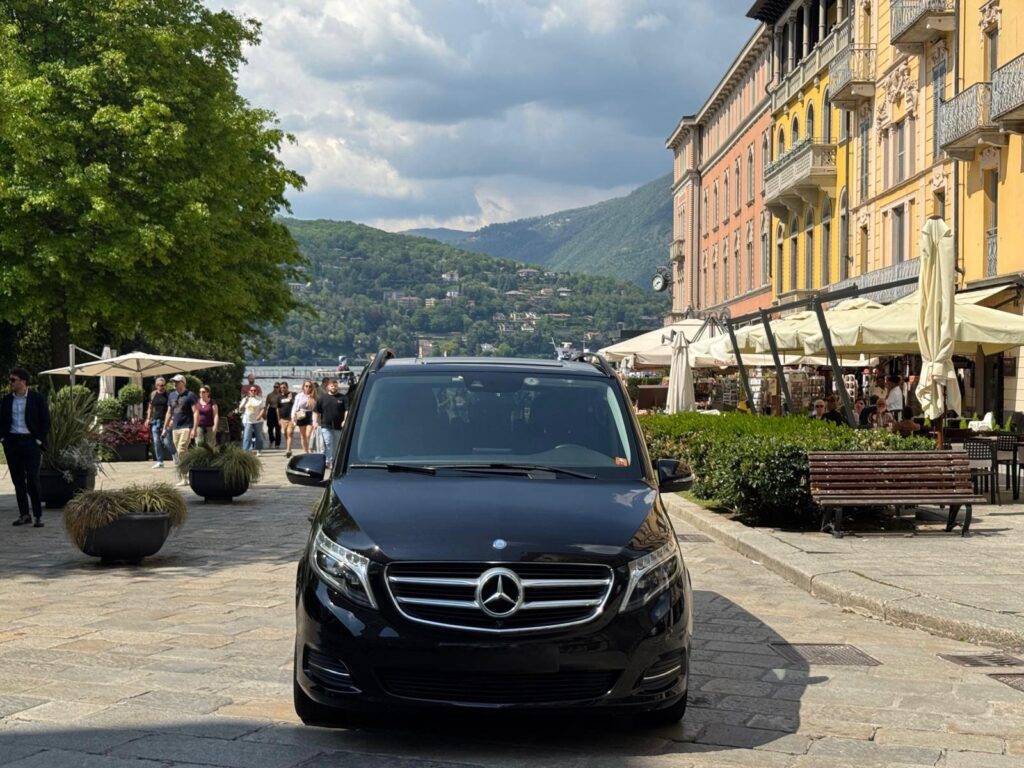 Black Mercedes van for private transfers overlooking Lake Como, offering scenic and exclusive chauffeur-driven travel.